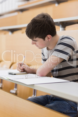 Concentrated student sitting while writing