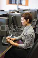 Concentrate woman sitting at the computer typing