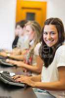 Student sitting at the computer smiling