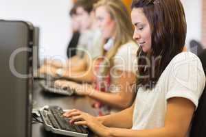 Woman looking at the keyboard in computer class in college