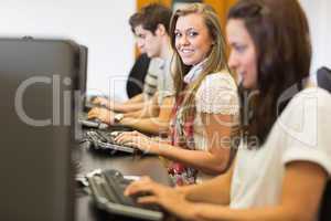 Students sitting at the computer smiling