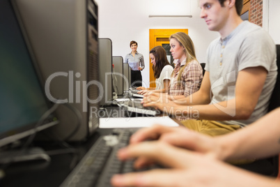 Concentrating students sitting at the computer in class