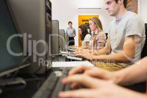 Concentrating students sitting at the computer in class