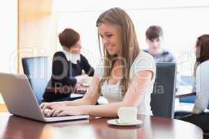 Woman sitting at the coffee shop using laptop