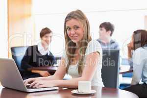 Woman sitting at the coffee shop at table using laptop