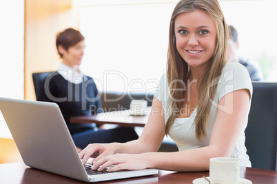 Student sitting at the coffee shop with laptop