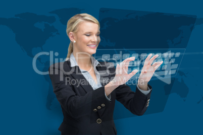 Businesswoman standing while typing on projected keyboard