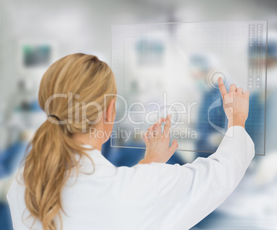 Doctor standing at the surgery with digital interface