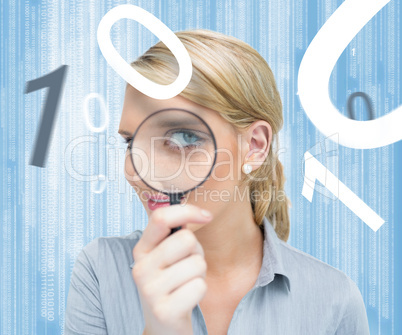 Woman looking through magnifying glass on digital background