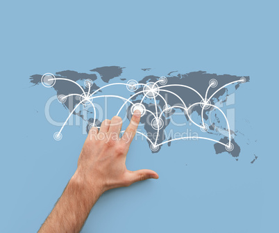 Hand touching a map showing global connections
