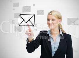 Businesswoman standing while touching email symbol