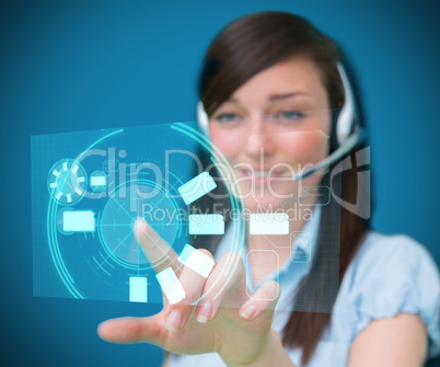 Woman wearing a head set smiling using digital interface