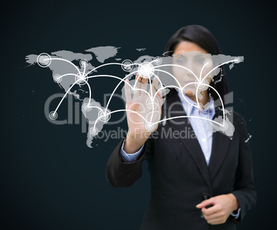 Businesswoman touching holographic world map