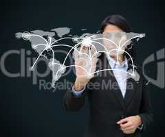 Businesswoman touching holographic world map