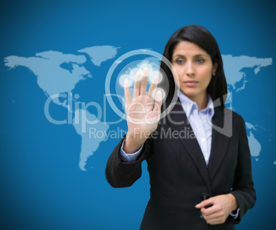 Businesswoman touching holographic screen against blue backgroun