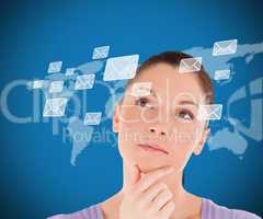 Woman standing while thinking on world map background