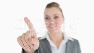 Smiling woman pointing in the air