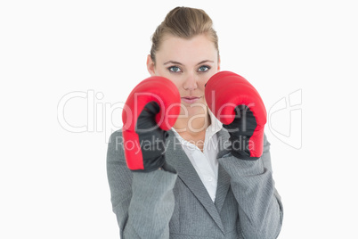 Businesswoman wearing boxing gloves