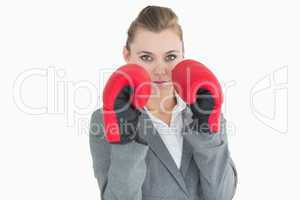 Businesswoman wearing boxing gloves