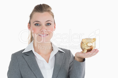 Businesswoman holding a piggy bank