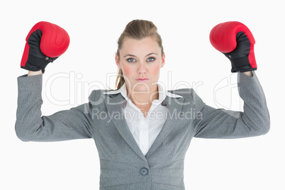 Businesswoman raising her hands with boxing gloves