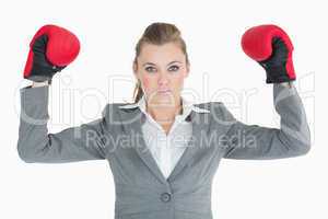 Businesswoman raising her hands with boxing gloves