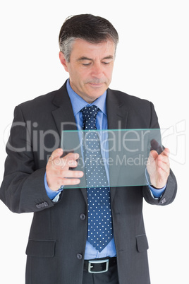 Businessman looking at clear pane