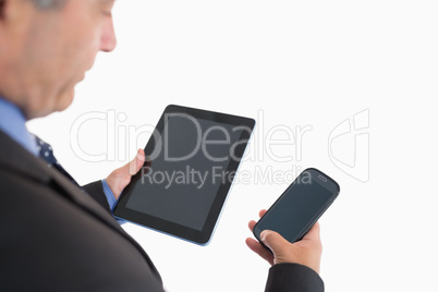 Businessman holding smartphone and tablet pc