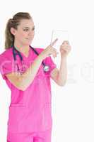 Joyful doctor touching pane