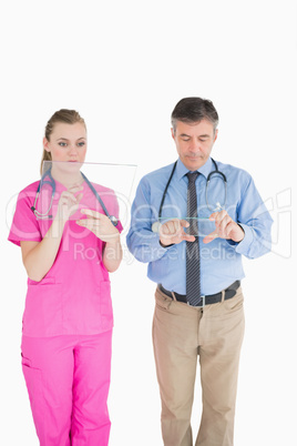 Doctors holding glass slides while being thoughtful