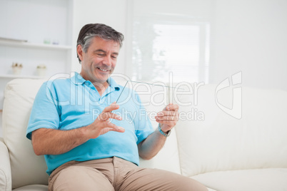 Smiling man holding an clear pane