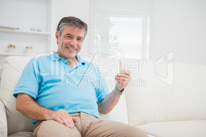 Man holding a pane while sitting on the sofa