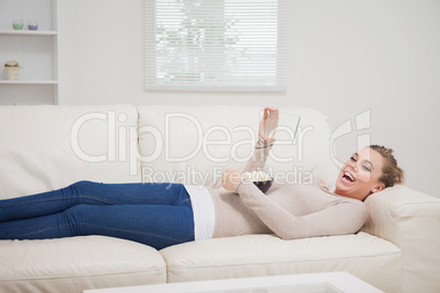Woman laughing at the clear pane while lying down