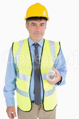 Man in helmet and vest holding a plan