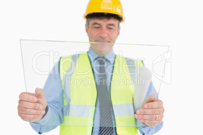 Man holding a huge glass slide while viewing it