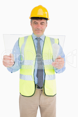 Smiling architect holding a pane
