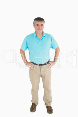 Smiling man with hands on hips