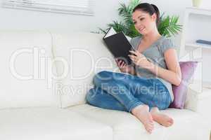 Reading woman sitting in a living room