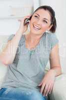 Phoning woman sitting on the couch