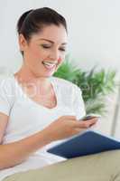 Woman having fun while using the tablet pc and a phone