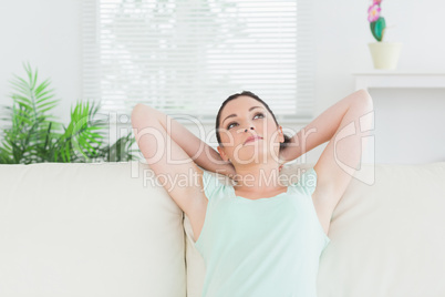 Carefree woman sitting on a couch