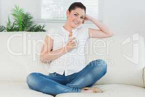 Woman sitting on the couch holding a cup