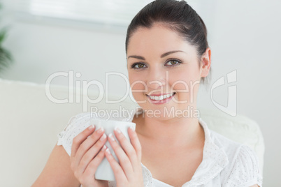 Woman sitting on the couch holding a mug