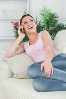 Phoning woman lying on the couch