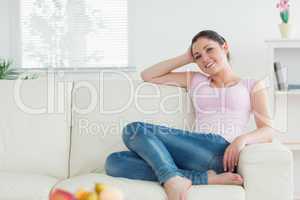 Woman sitting on the couch in a living room and relaxing