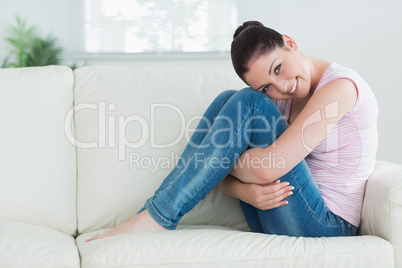 Woman relaxing while sitting in a living room