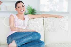 Woman relaxing while sitting on a couch