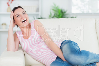 Laughing woman relaxing on the couch