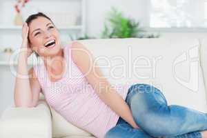 Laughing woman relaxing on the couch