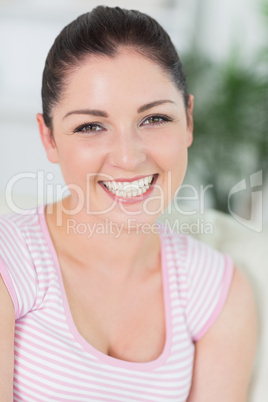 Relaxing woman sitting in a living room on a couch